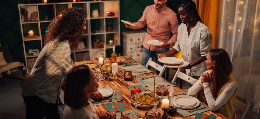 Happy,Multiethnic,Friends,Setting,The,Table,For,Thanksgiving,Or,Friendsgiving